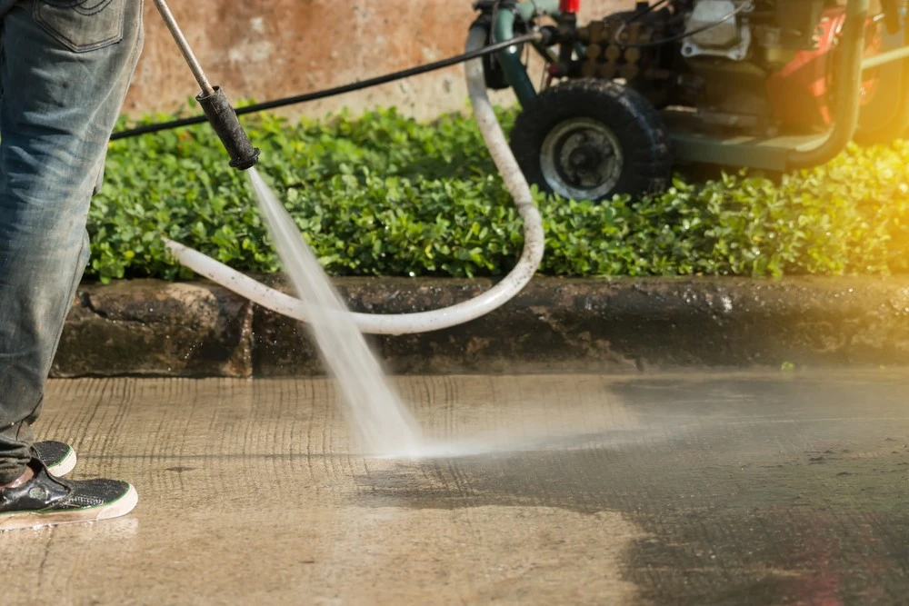 Technician performing professional pressure washing for a residential propert in lafayette,louisiana