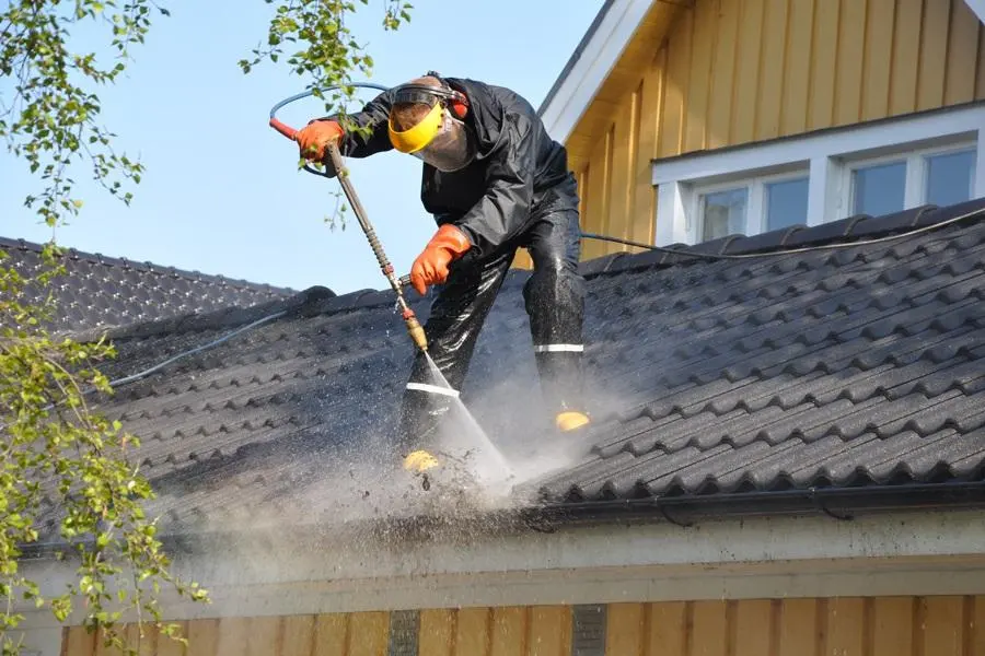 Professional roof pressure washing service cleaning residential roof in Lafayette LA