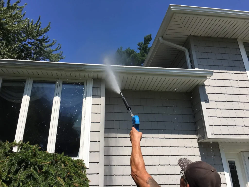 Residential house soft washing service in Lafayette cleaning exterior siding and removing dirt safely