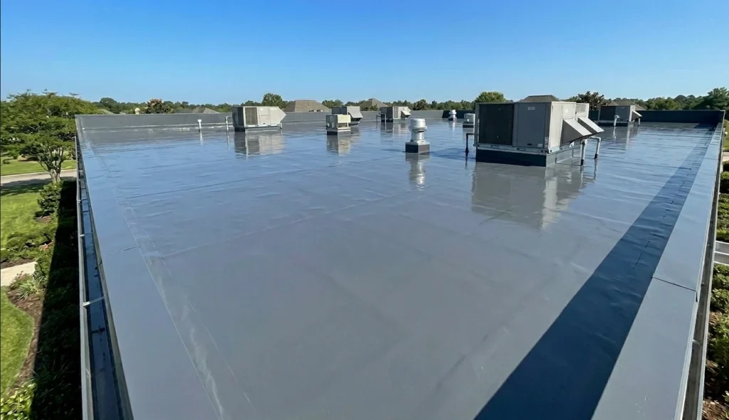 Commercial flat roof with a new protective gray coating in Lafayette after professional restoration service.
